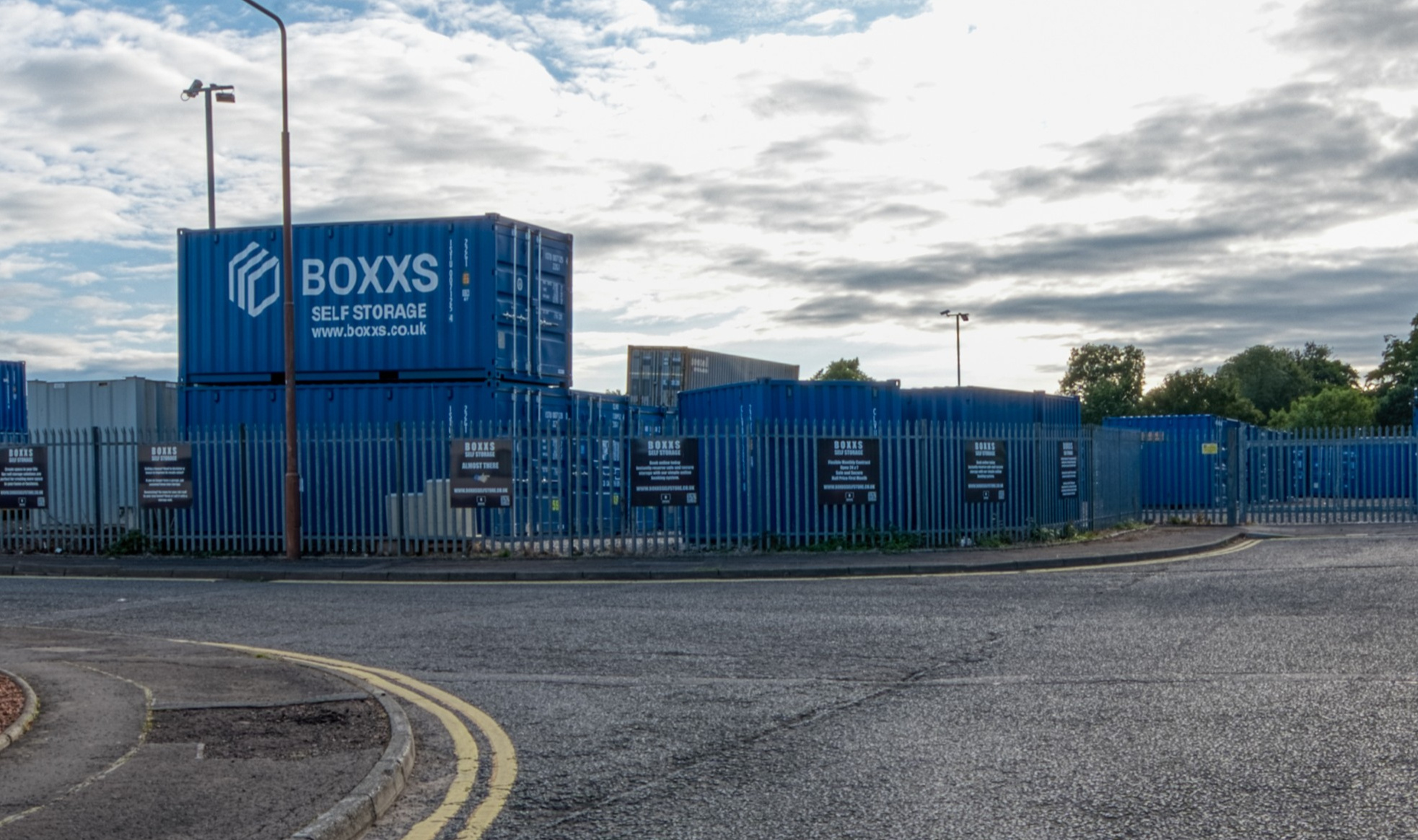 Alternate angle of Boxxs self storage container with painted logo at the Linlithgow entrance, highlighting secure access for West Lothian and Falkirk customers
